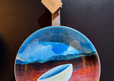 Over the Easy Planes V, 2025, 12x8.5”, acrylics on decommissioned frying pan. Price: $250 Artist’s description: These whimsical pieces are a tribute to the hardworking cooks out there, recognizing their craft as fine art. It is also a tribute to all the used and abused frying pans in the world!